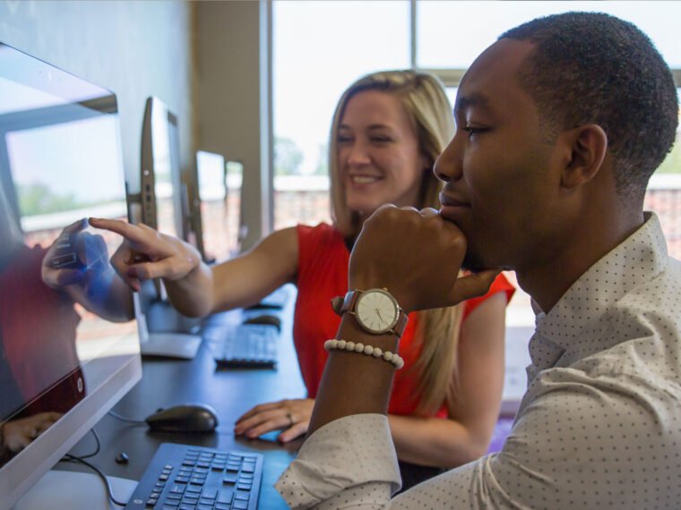 HSU students sitting at a computer talking