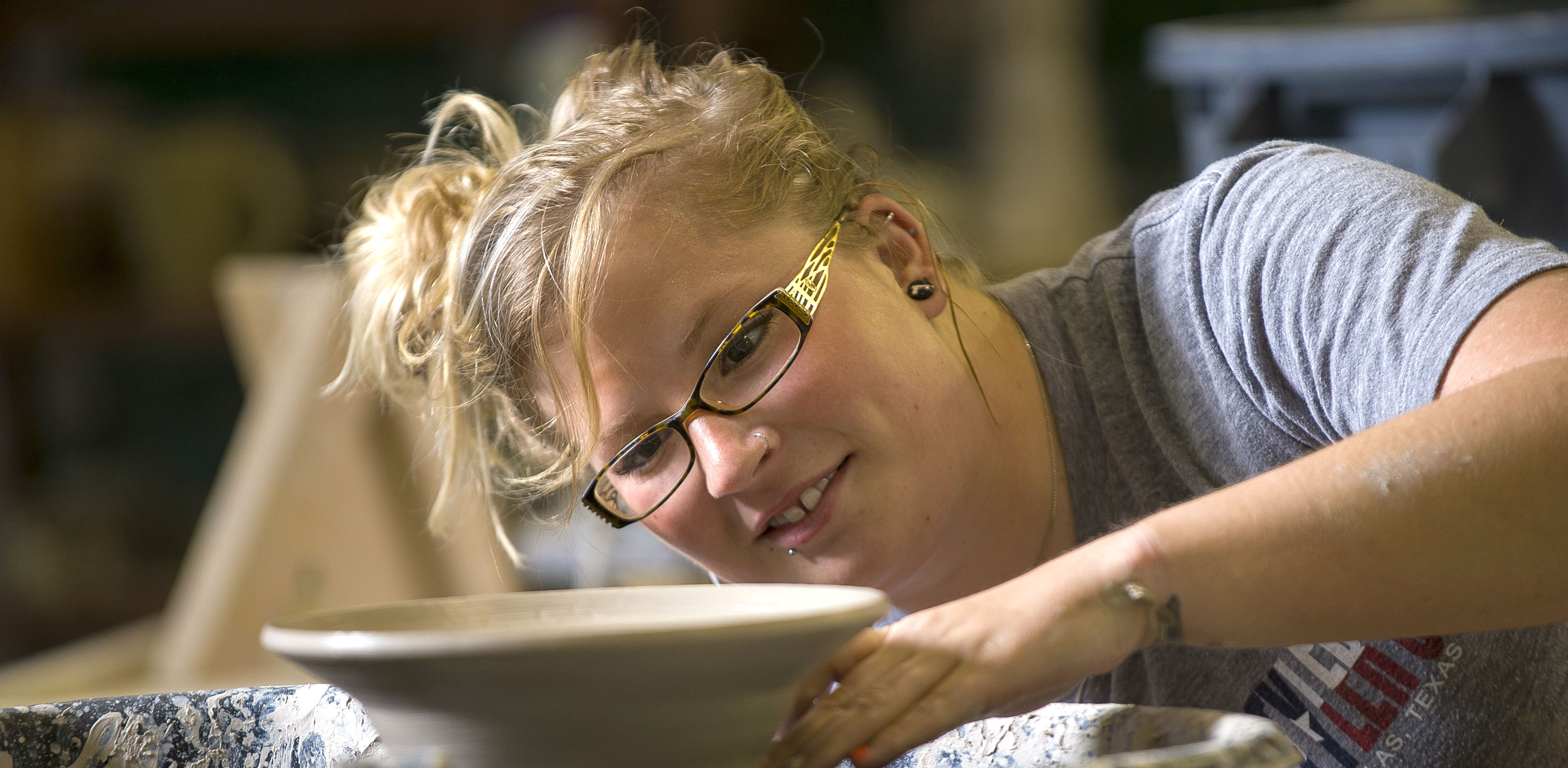 Art Program student making pottery in class