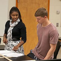 biology professor and student sharing ideas in class