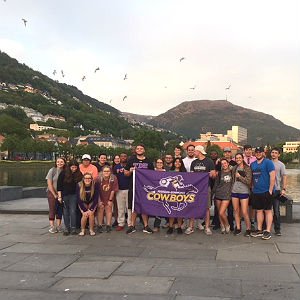 students taking group photo abroad with HSU flag