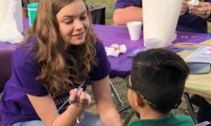 CSD student painting a kid's face at an HSU event.