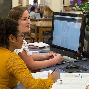 HSU students sitting at a computer studying in the library