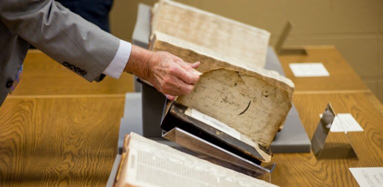 Professor opening old history book