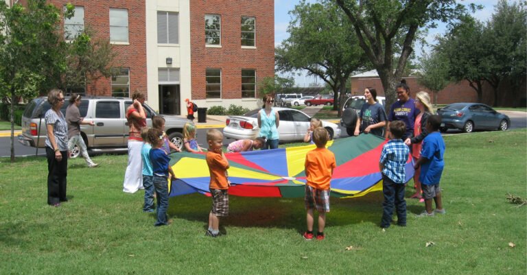 Human Services students playing parachute with kids