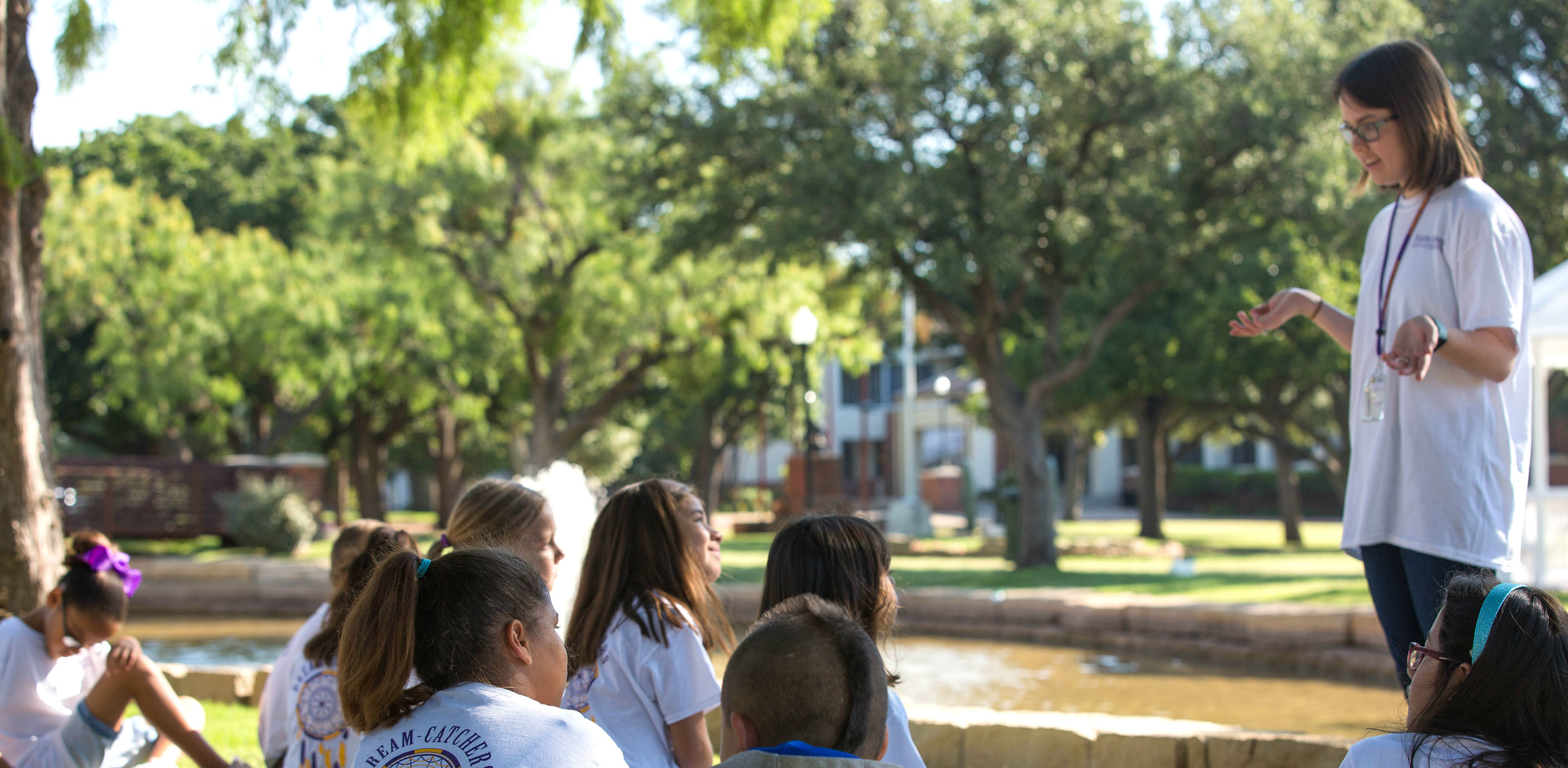 Teacher speaking to a group of children