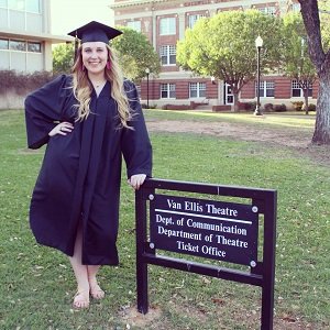 A Theatre graduate posing for the camera.