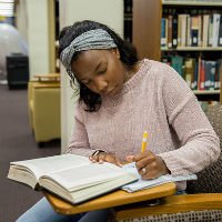 HSU student taking notes at the library