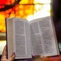 student holding Bible open