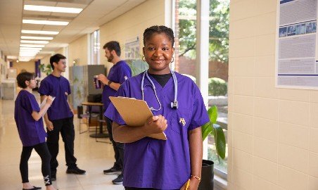 Nursing students in a hallway.