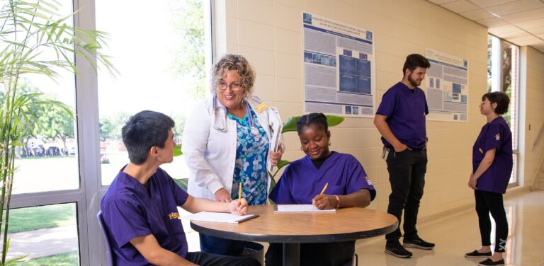 A nursing professor speaks to nursing students.