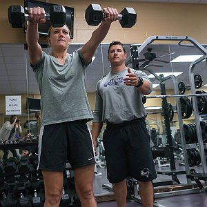 Physical Education students training and lifting weights