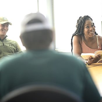 Strategic Communication students sitting at a table talking