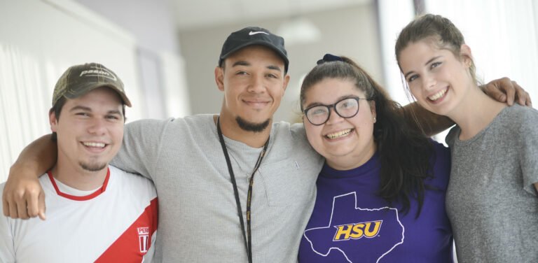 HSU Strategic Communication students stand together and smile for a picture