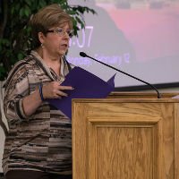 History Department Head stands behind a podium