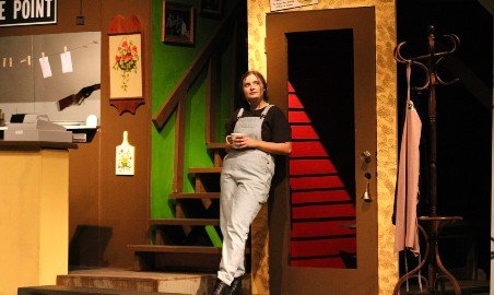 Female student in a theatre production.
