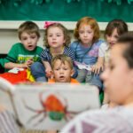 HSU Education Program student reading book to small children