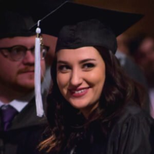 Photo of a female HSU student in cap and gown at graduation.