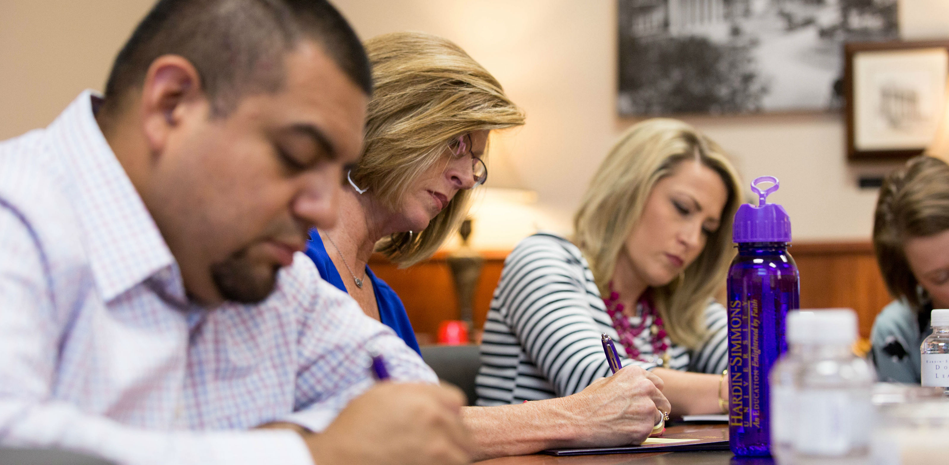 Leadership students taking notes in class