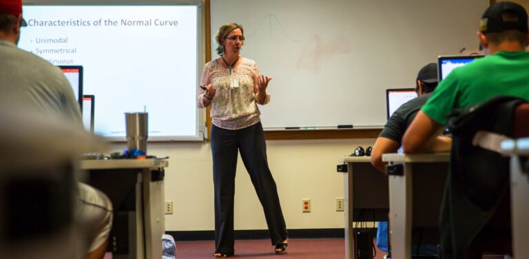 Kinesiology professor standing in front of classroom full of students