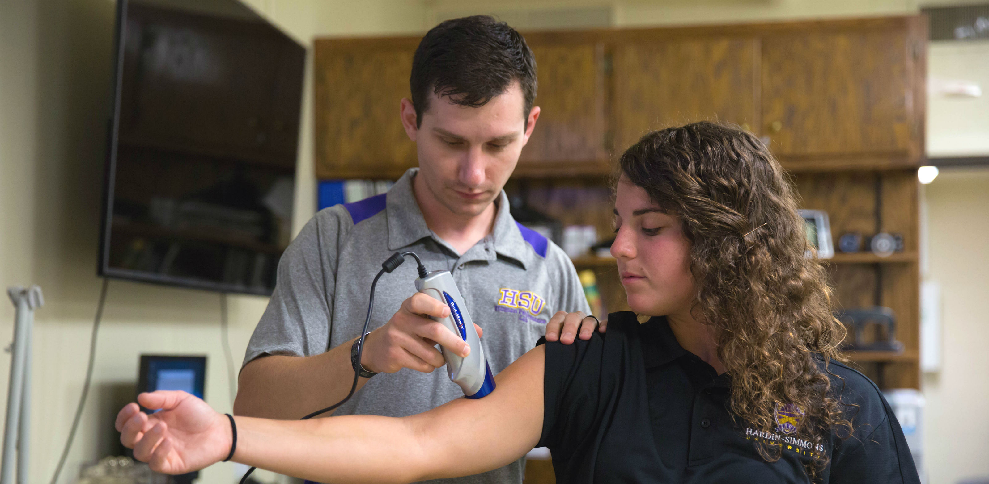 Master of Science in Kinesiology student practices clinicals with patient