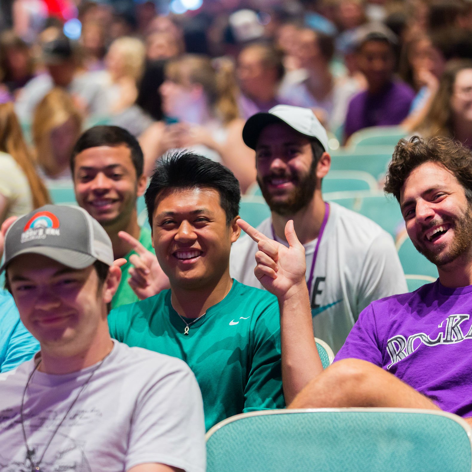 HSU students sitting at worship giving the school sign