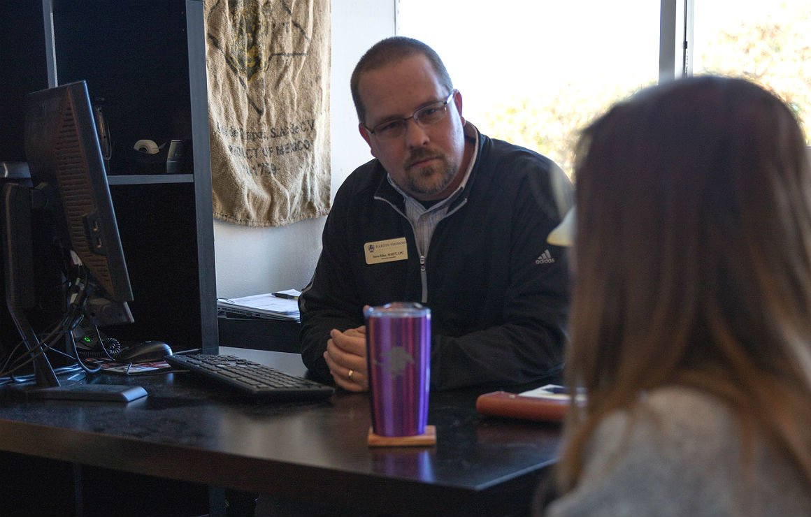 HSU faculty member speaking with student in office