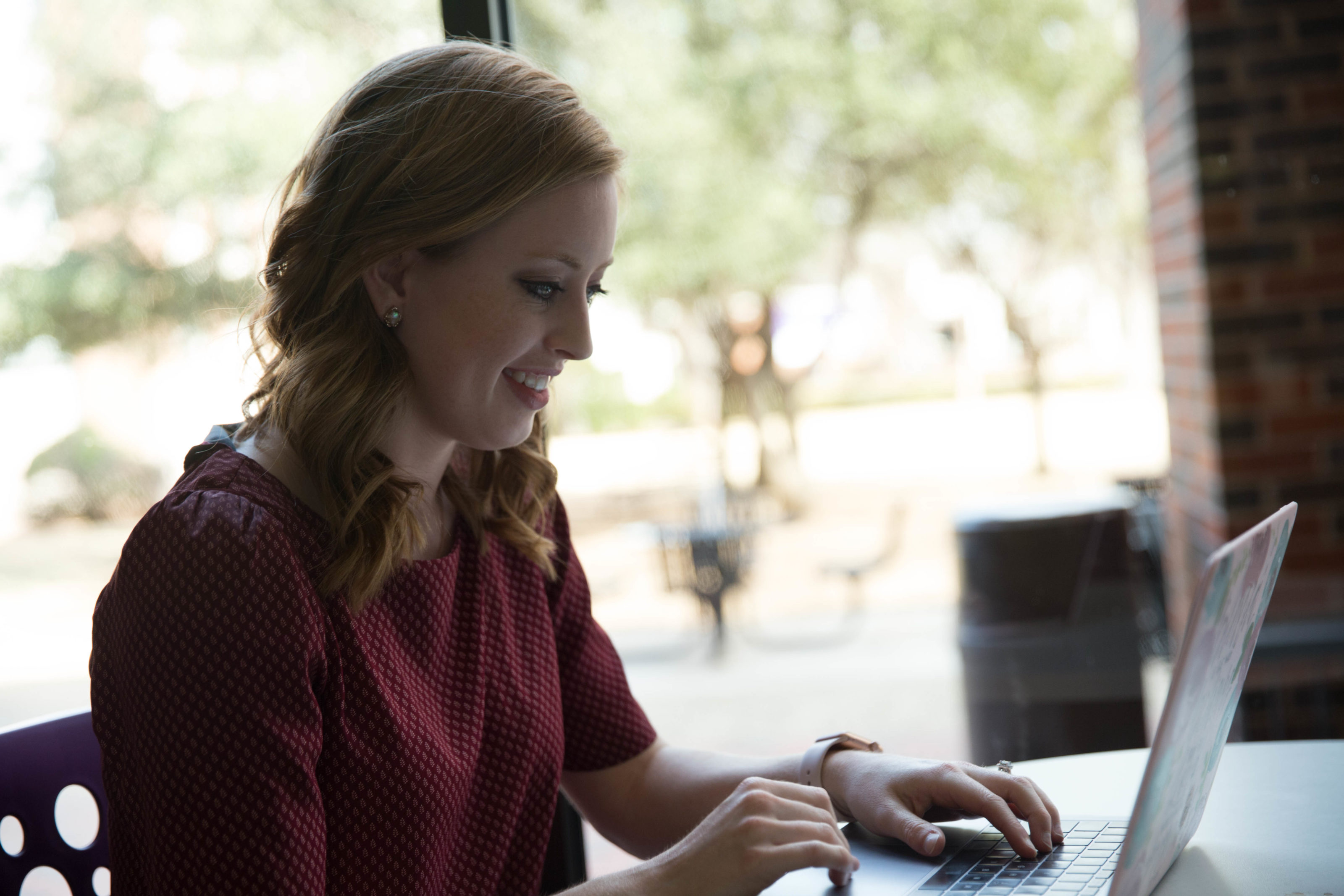 HSU Finance Program student working on her laptop