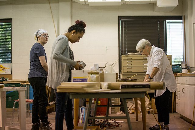 HSU Art professor and student creating art at a work table in an art studio