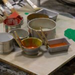 paint brushes and cans in an art studio