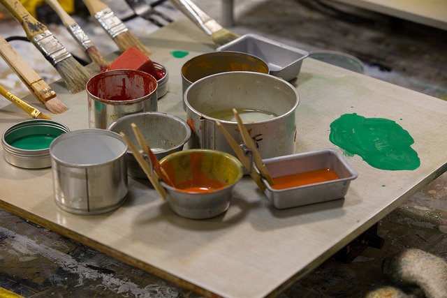 paint brushes and cans in an art studio