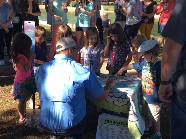 HSU Exploration Station students participate in an activity table with a teacher