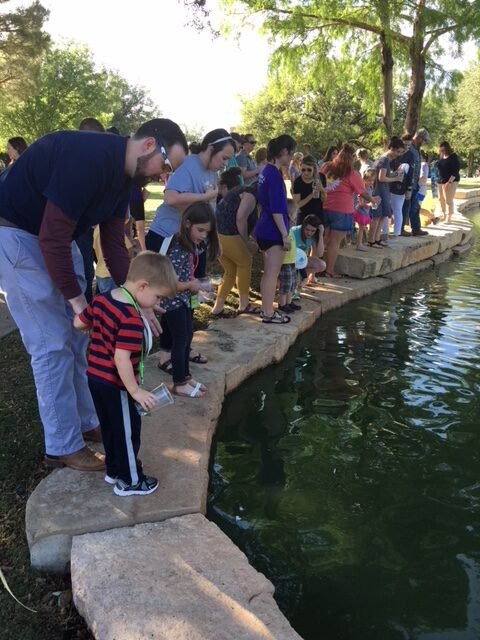 HSU Exploration Station students and parents stand on the edge of a creek