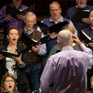 HSU music professor leading choir of students