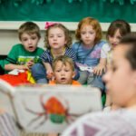 HSU Education Program student reading book to small children