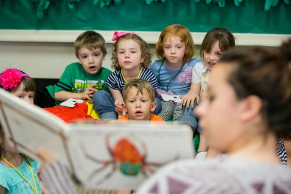 HSU Education Program student reading book to small children