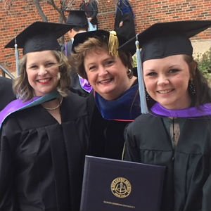 Master of Education in Gifted Education alumni at graduation wearing caps and gowns