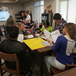 Master of Education in Gifted Education students review notes together at table
