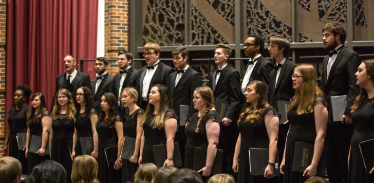 HSU choir formally dressed singing on stage