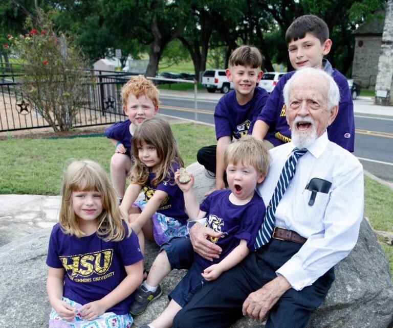 Kids with HSU T-shirts posing with their grandfather.