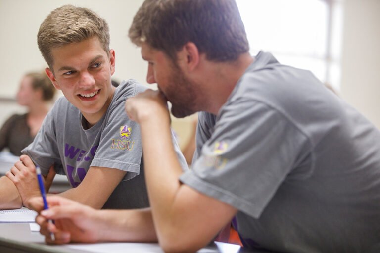 HSU students in class talking and smiling