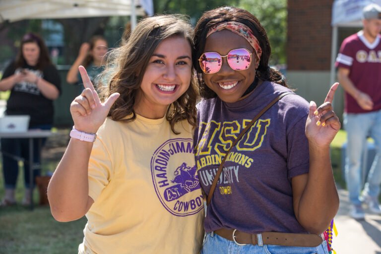 students in spirit wear giving the HSU hand sign
