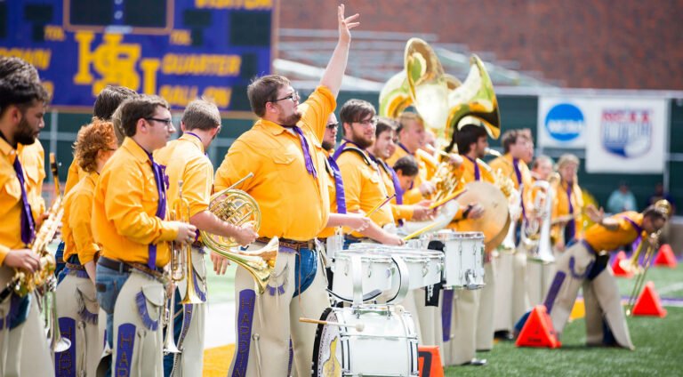 HSU band performing halftime show on football field