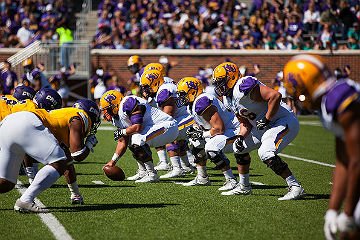 HSU football players setting up play at a game