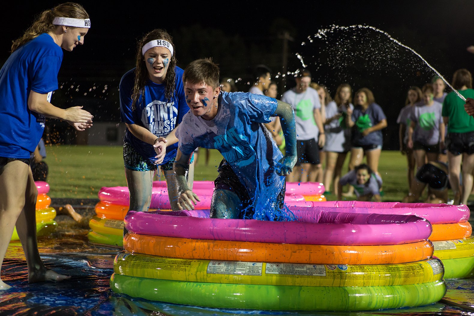HSU students participate in an obstacle course involving paint