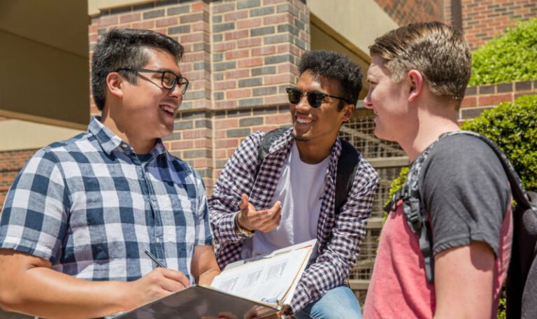 HSU students smiling and talking outside on campus