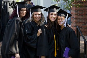 HSU students in cap and gown standing in line at graduation