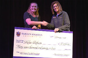 student receiving giant check for HSU tuition