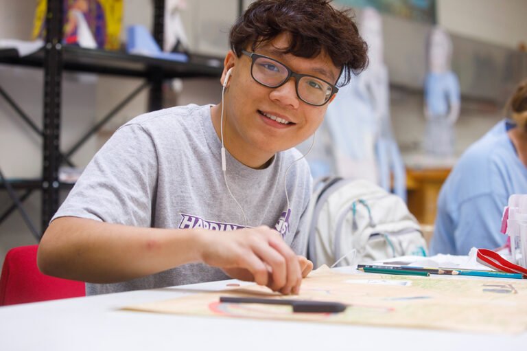 HSU student in art class drawing with colored pencils