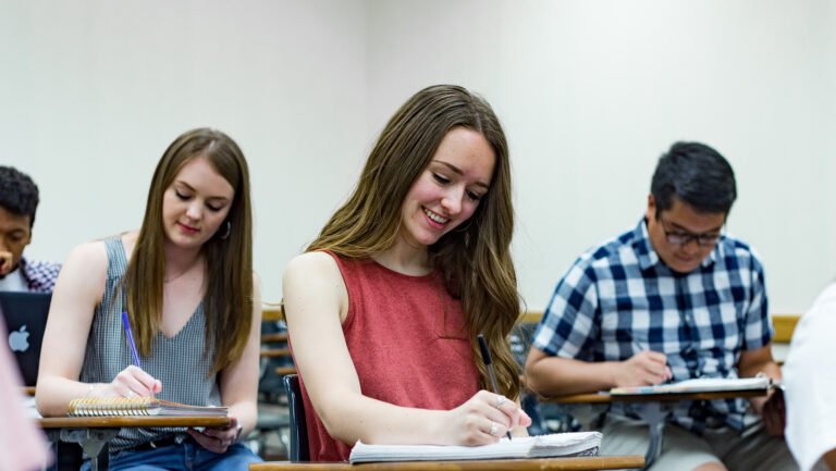 Photo of student writing notes in classroom