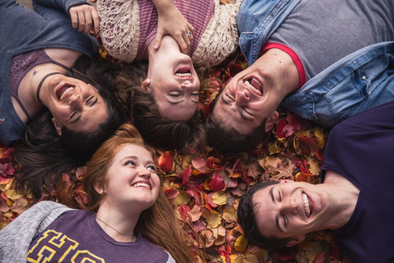 Picture of Students laughing in leaves